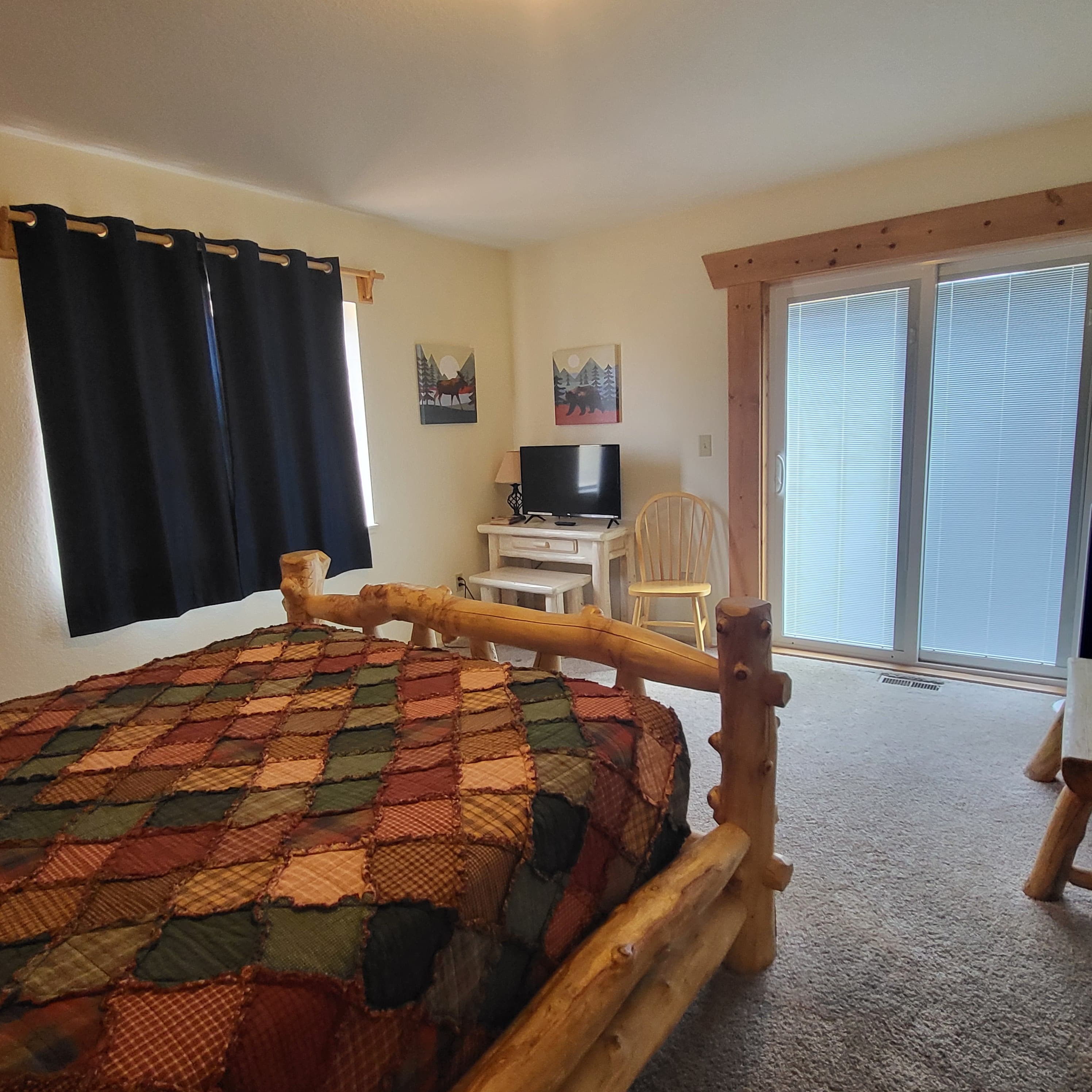 Mt. Harvard Room Queen Log Bed with the Sitting Are and a door going out the Deck