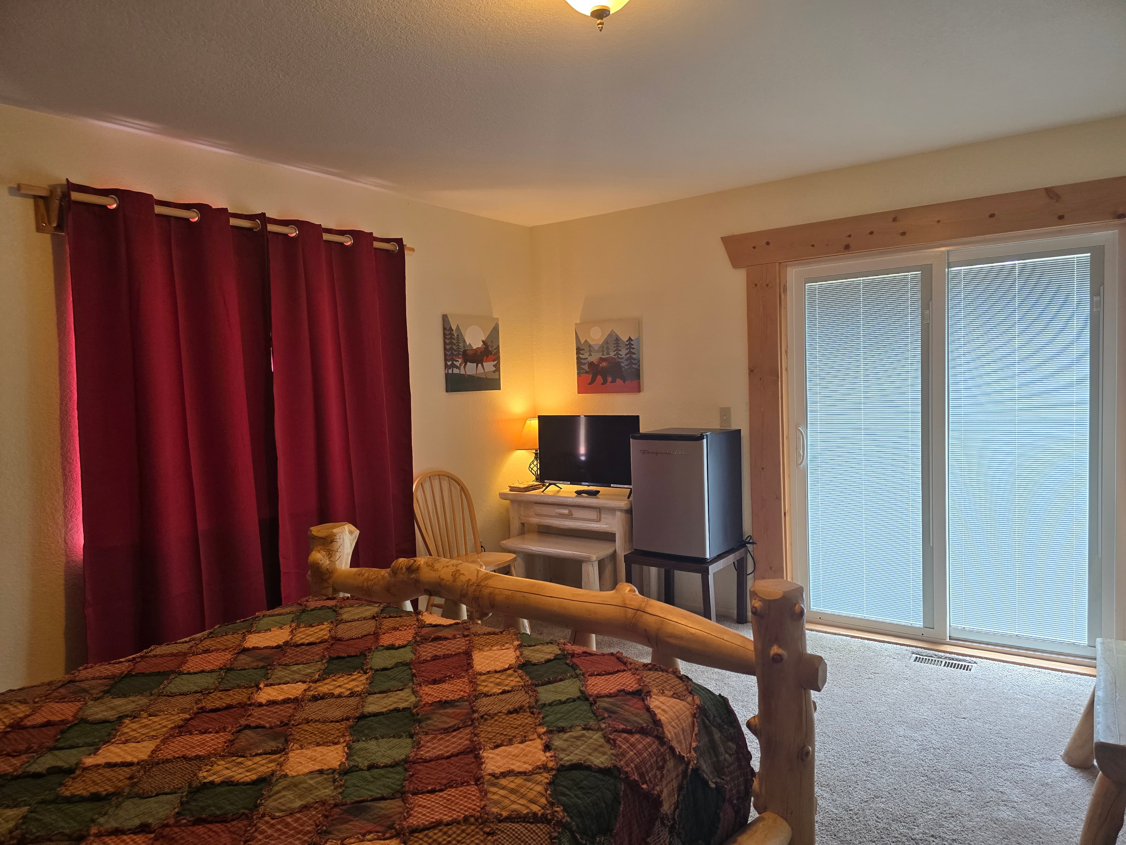 Mt. Harvard Room Queen Log Bed with the Sitting Are and a door going out the Deck